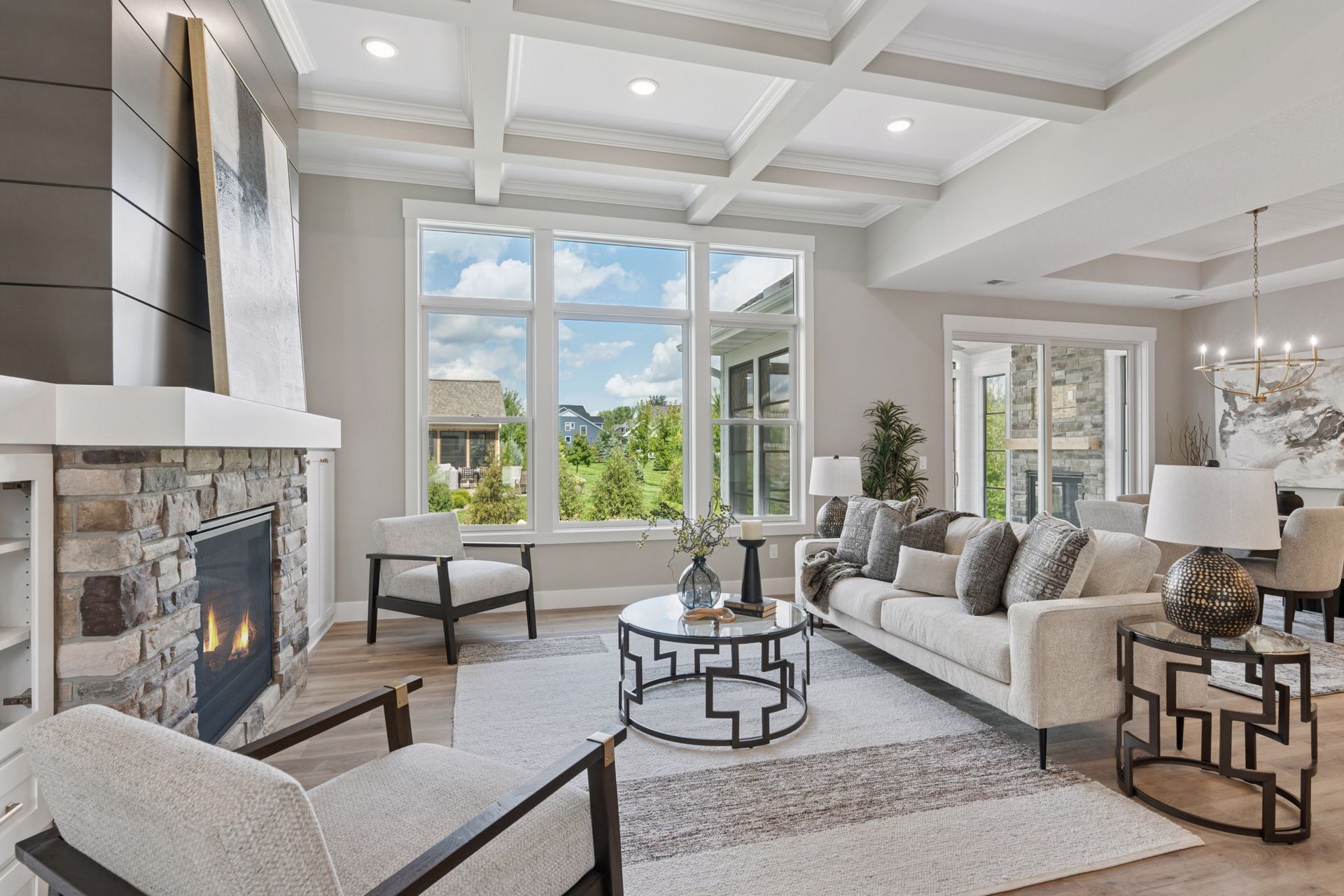 Luxury home interior with open floor plan and detailed coffered ceiling