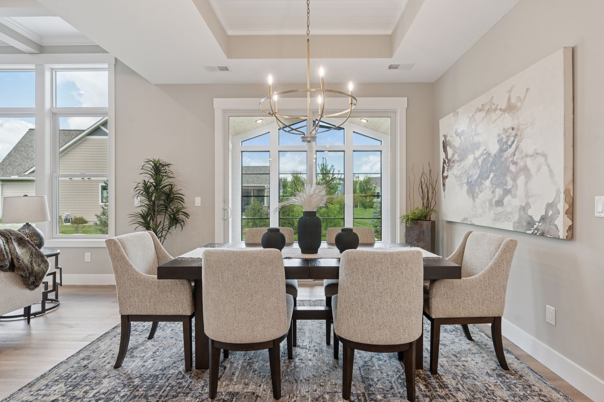 Dining room with vaulted ceiling and patio slider doors to four-season porch