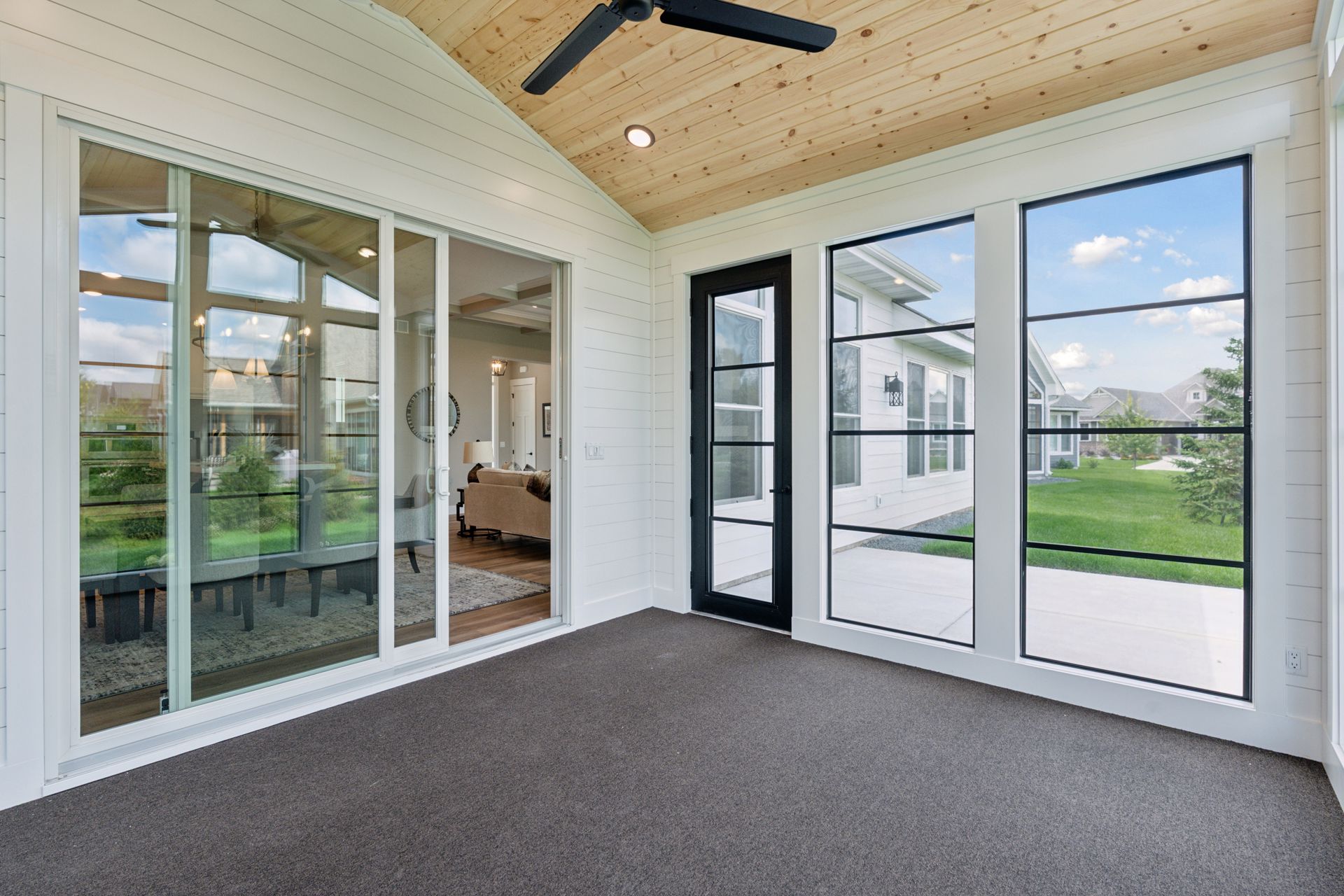 Vaulted four-season porch featuring tongue-and-groove pine and ceiling fan