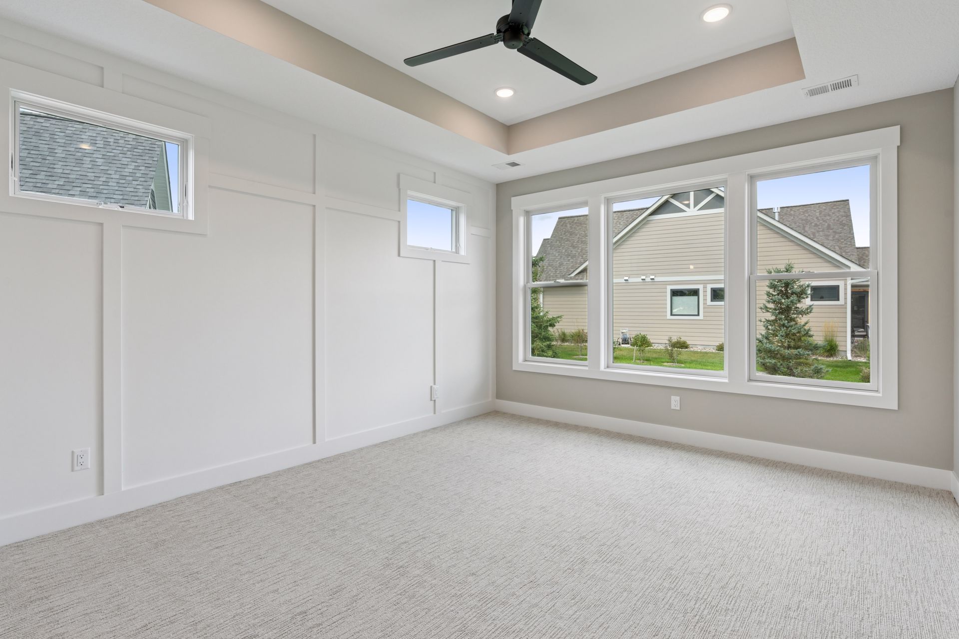 Owner’s suite with special wall details, large piano windows, and triple window