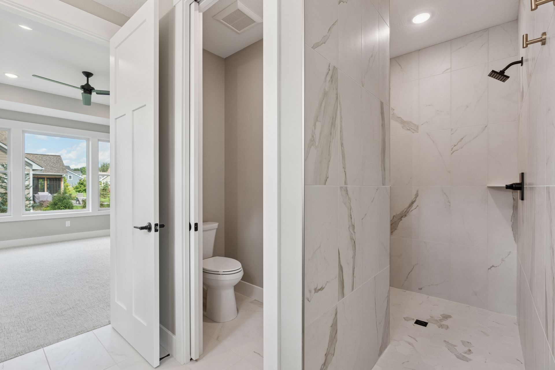 Spa-like large walk-in tile shower with elegant fixtures