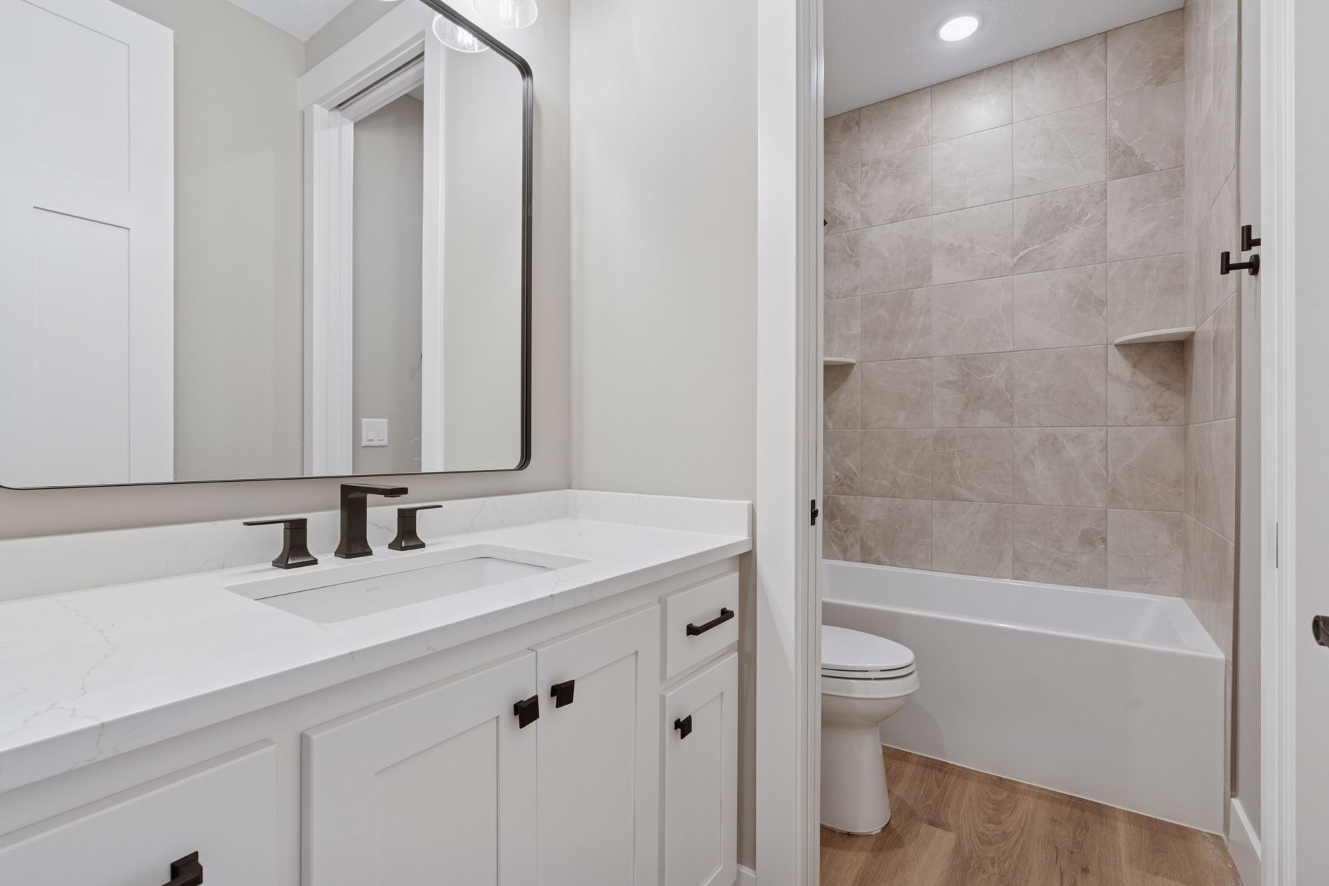 Bath featuring pocket door, private water closet, and combined tub and shower
