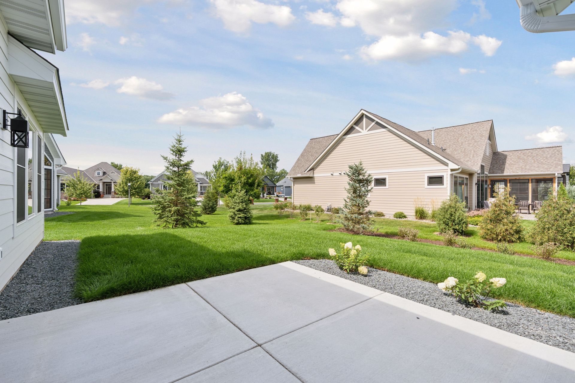 Spacious outdoor patio overlooking landscaped, park-like yard