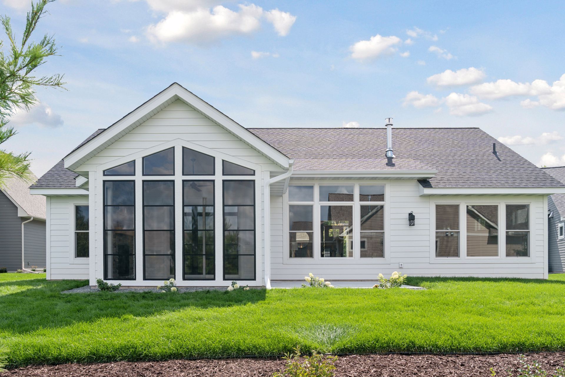 Large Andersen 200 Series windows overlooking landscaped yard