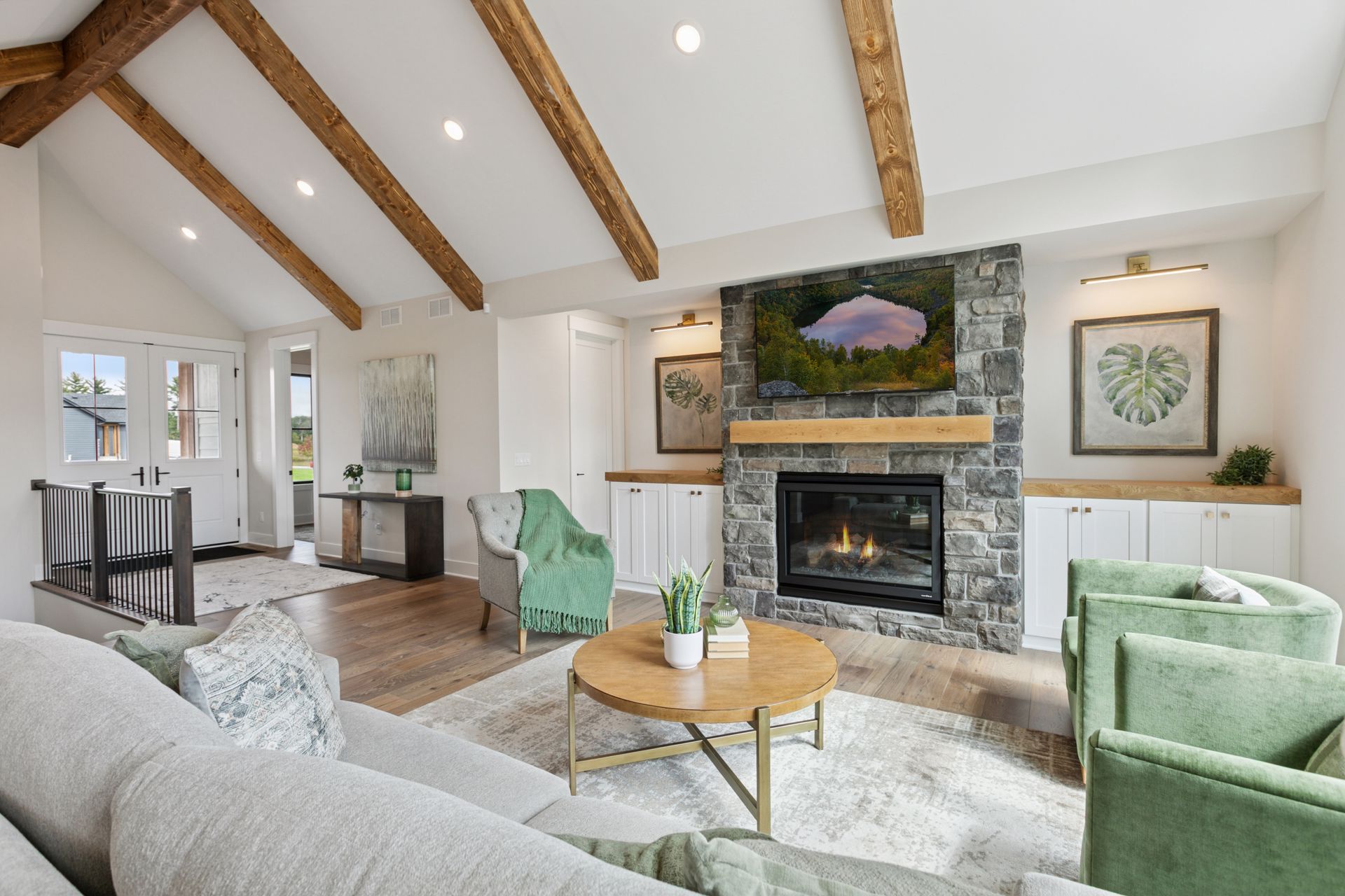 Great room media wall with built-in cabinets and display niche